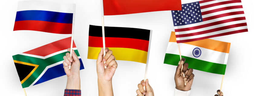 Hands waving flags of China, Germany, India, South Africa, and Russia